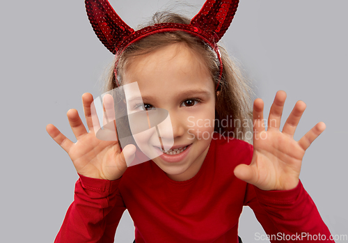 Image of girl costume with devil's horns on halloween