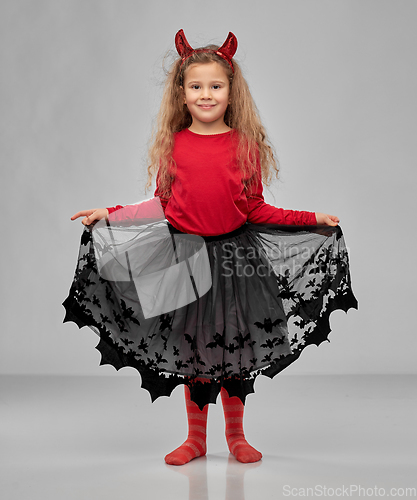 Image of girl in halloween costume and devil's horns