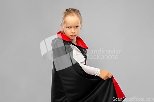 Image of girl in costume of dracula with cape on halloween