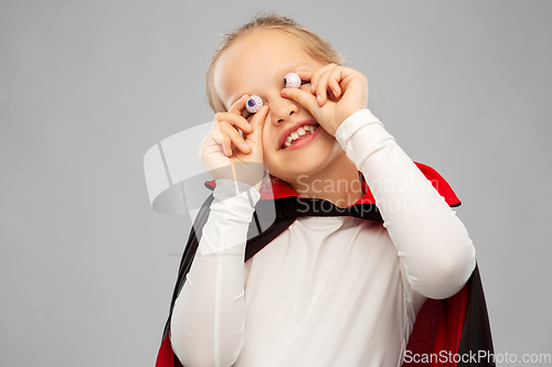 Image of girl in halloween costume of dracula with eyeballs