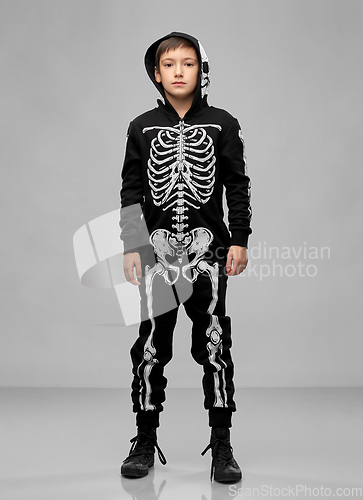 Image of boy in black halloween costume with skeleton bones