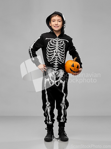 Image of happy boy in halloween costume with jack-o-lantern