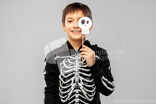 Image of boy in halloween costume of skeleton with scull