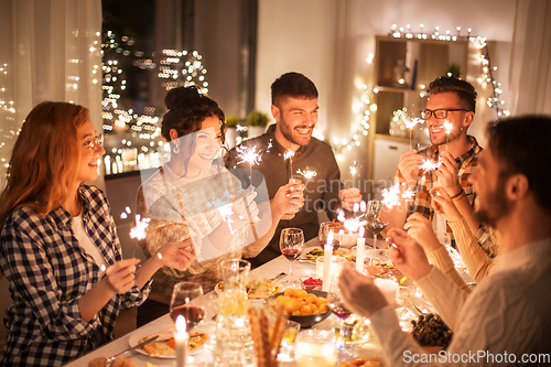 Image of happy friends having christmas dinner at home