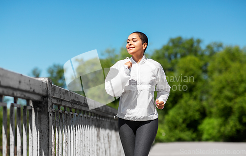 Image of african american woman running outdoors