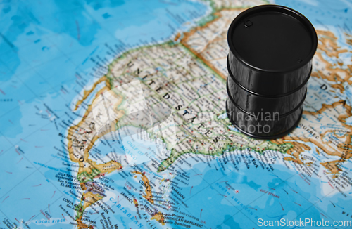 Image of Oil drum with crude petroleum standing on a map