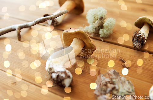 Image of boletus edulis mushrooms on wooden background