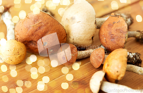 Image of brown cap boletus mushrooms on wooden background