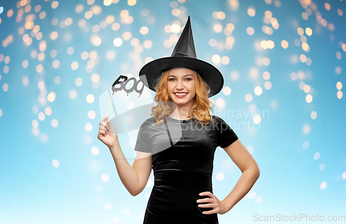 Image of woman in halloween costume of witch with accessory