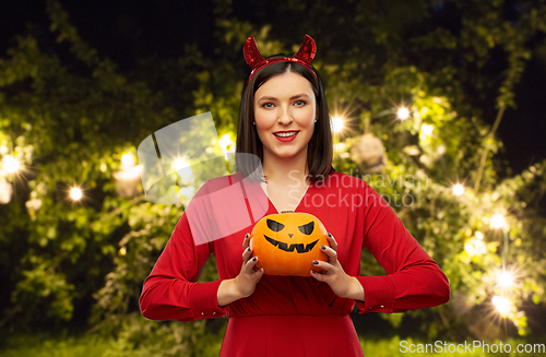 Image of woman in halloween costume of devil with pumpkin