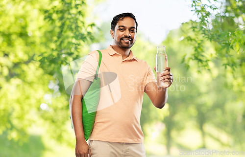 Image of man with bag for food shopping and glass bottle