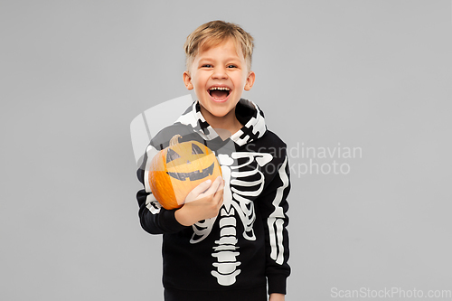 Image of happy boy in halloween costume with jack-o-lantern