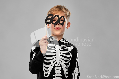 Image of boy in halloween costume of skeleton making faces