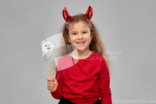 Image of girl in halloween costume with ghost party prop