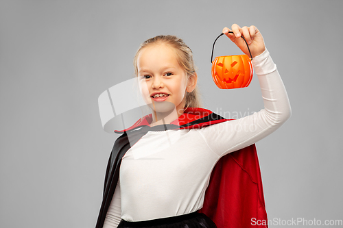 Image of girl in halloween costume of dracula with pumpkin