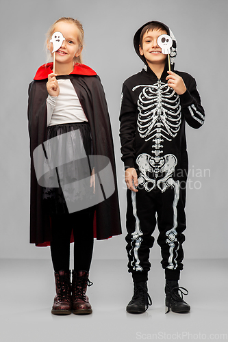 Image of children in halloween costumes with party props