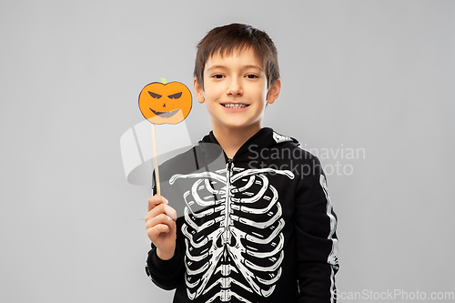 Image of boy in halloween costume of skeleton with pumpkin