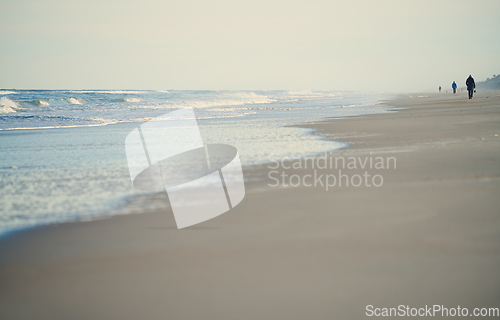 Image of Incidental people walking along the beach of Atlantic Ocean. USA