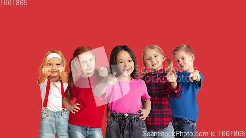 Image of Portrait of little children gesturing isolated on red studio background with copyspace