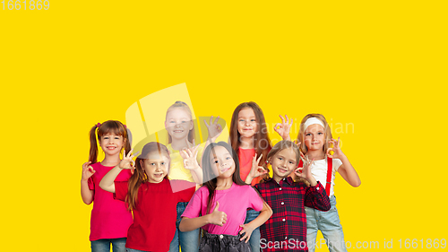 Image of Portrait of little children gesturing isolated on yellow studio background with copyspace