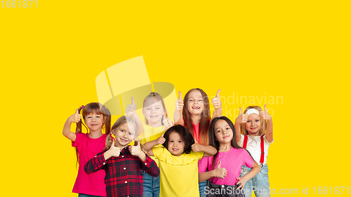 Image of Portrait of little children gesturing isolated on yellow studio background with copyspace