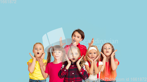 Image of Portrait of little children gesturing isolated on blue studio background with copyspace