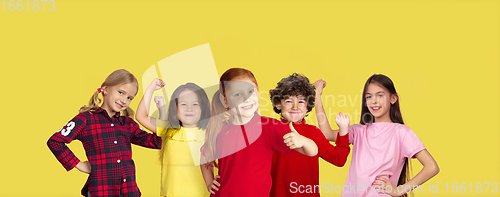 Image of Portrait of little children gesturing isolated on yellow studio background with copyspace