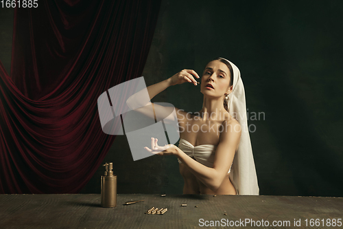 Image of Modern remake of classical artwork with coronavirus theme - young medieval woman on dark background