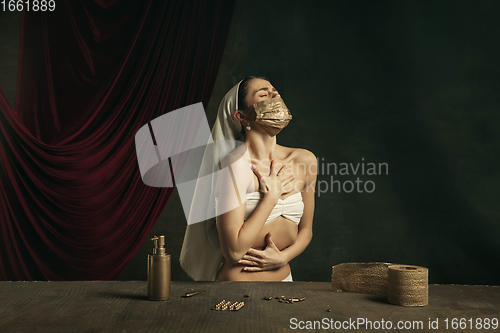 Image of Modern remake of classical artwork with coronavirus theme - young medieval woman on dark background