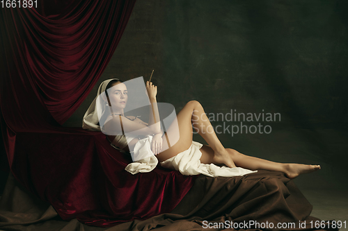 Image of Modern remake of classical artwork with coronavirus theme - young medieval woman on dark background