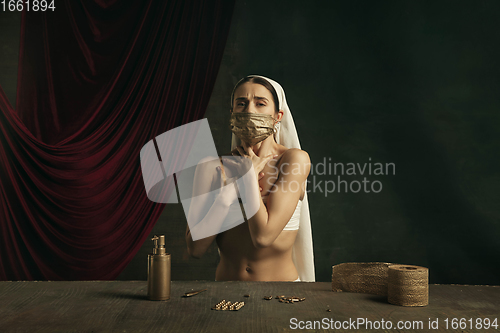 Image of Modern remake of classical artwork with coronavirus theme - young medieval woman on dark background