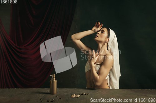 Image of Modern remake of classical artwork with coronavirus theme - young medieval woman on dark background