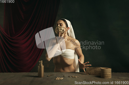 Image of Modern remake of classical artwork with coronavirus theme - young medieval woman on dark background