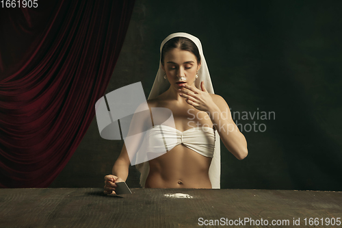 Image of Modern remake of classical artwork with coronavirus theme - young medieval woman on dark background