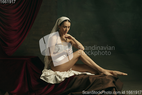 Image of Modern remake of classical artwork with coronavirus theme - young medieval woman on dark background