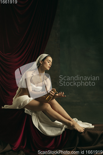 Image of Modern remake of classical artwork with coronavirus theme - young medieval woman on dark background