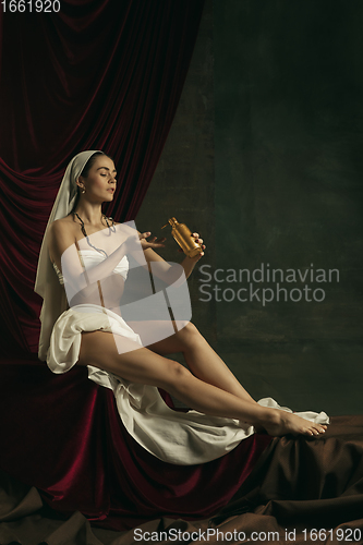 Image of Modern remake of classical artwork with coronavirus theme - young medieval woman on dark background