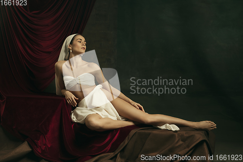 Image of Modern remake of classical artwork with coronavirus theme - young medieval woman on dark background