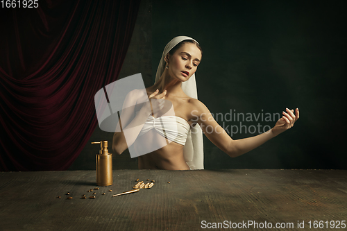 Image of Modern remake of classical artwork with coronavirus theme - young medieval woman on dark background