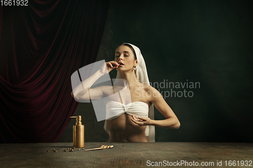 Image of Modern remake of classical artwork with coronavirus theme - young medieval woman on dark background