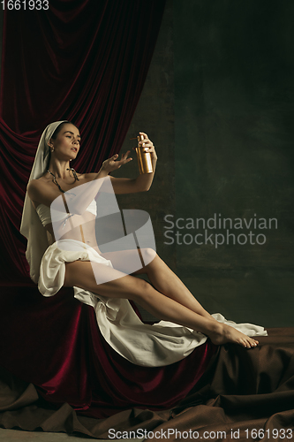 Image of Modern remake of classical artwork with coronavirus theme - young medieval woman on dark background