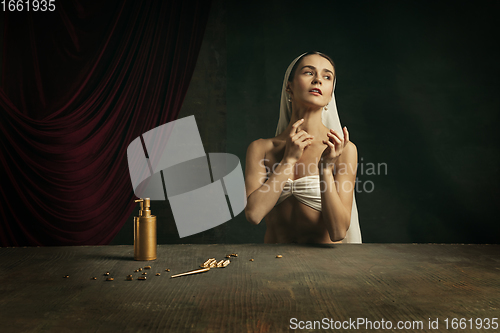 Image of Modern remake of classical artwork with coronavirus theme - young medieval woman on dark background