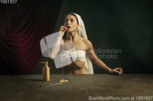 Image of Modern remake of classical artwork with coronavirus theme - young medieval woman on dark background