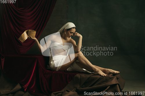 Image of Modern remake of classical artwork with coronavirus theme - young medieval woman on dark background