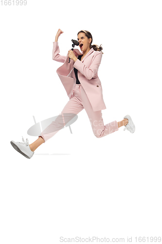 Image of Happy young woman dancing in stylish clothes or suit, remaking legendary moves of celebrity from culture history