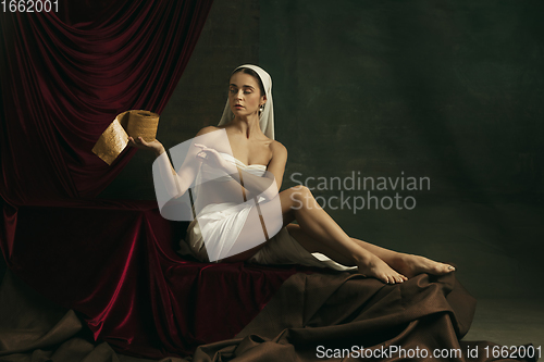 Image of Modern remake of classical artwork with coronavirus theme - young medieval woman on dark background