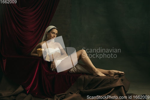 Image of Modern remake of classical artwork with coronavirus theme - young medieval woman on dark background