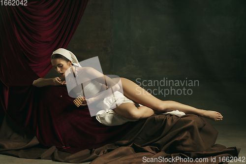 Image of Modern remake of classical artwork with coronavirus theme - young medieval woman on dark background