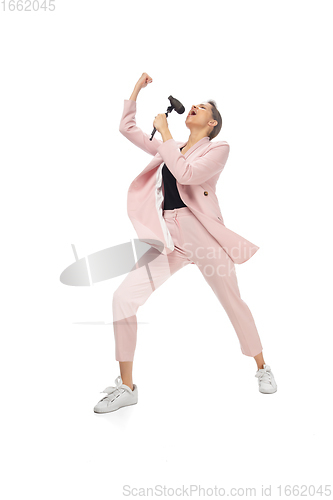 Image of Happy young woman dancing in stylish clothes or suit, remaking legendary moves of celebrity from culture history