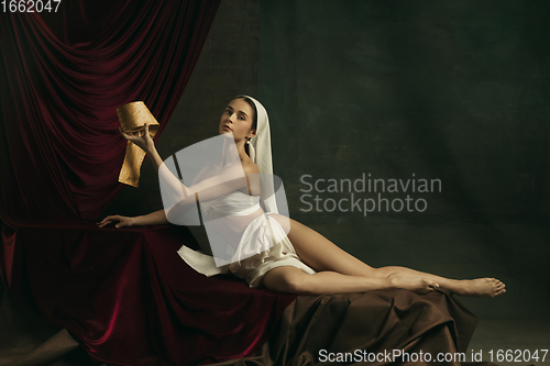 Image of Modern remake of classical artwork with coronavirus theme - young medieval woman on dark background